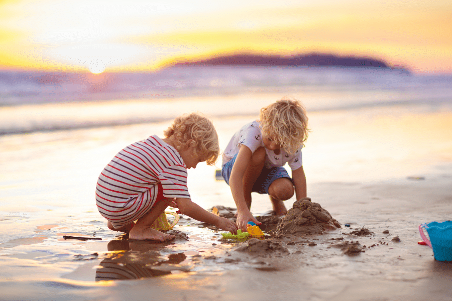 Blonde kids playing on the beach