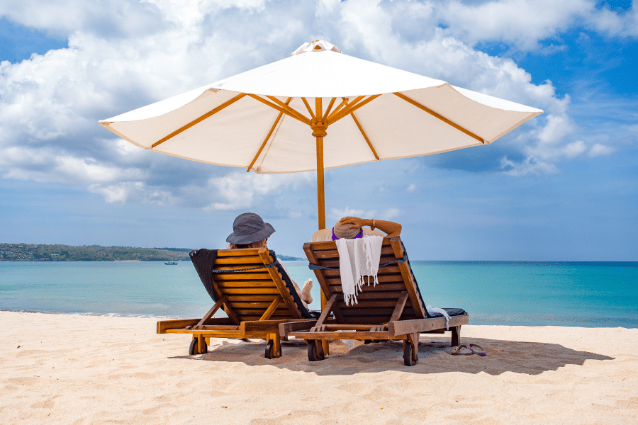 Couple at the beach under umbrella